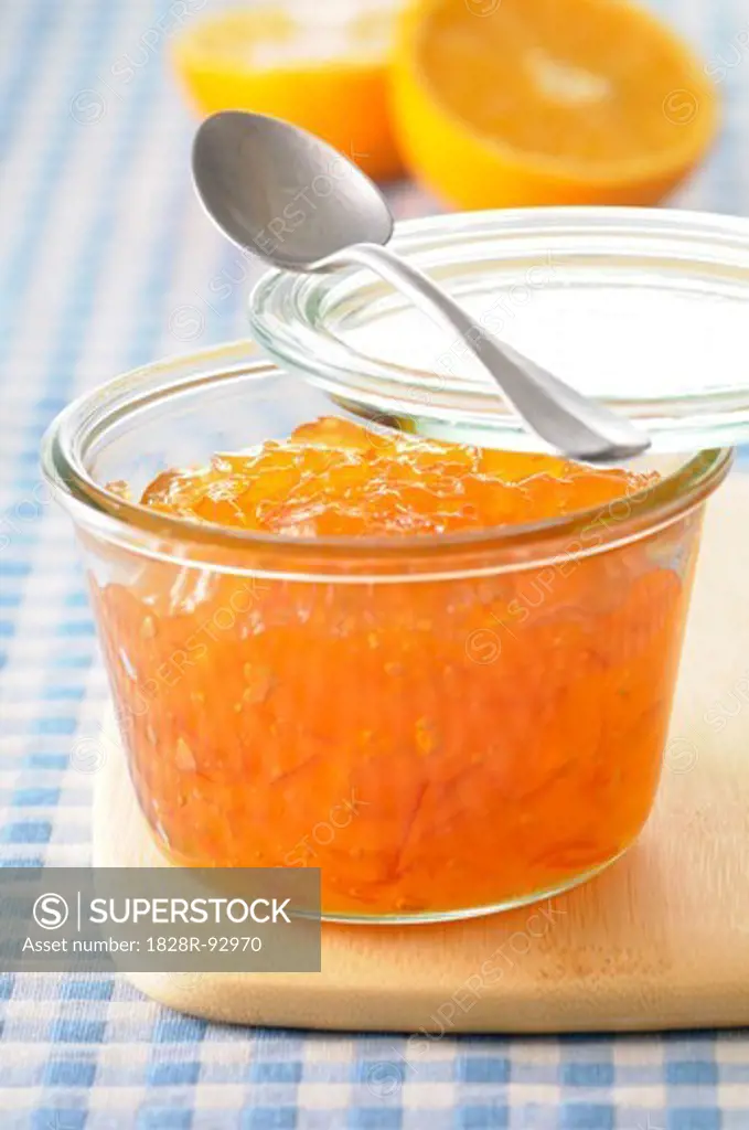 Close-up of Homemade Orange Marmalade with Spoon on Cutting Board