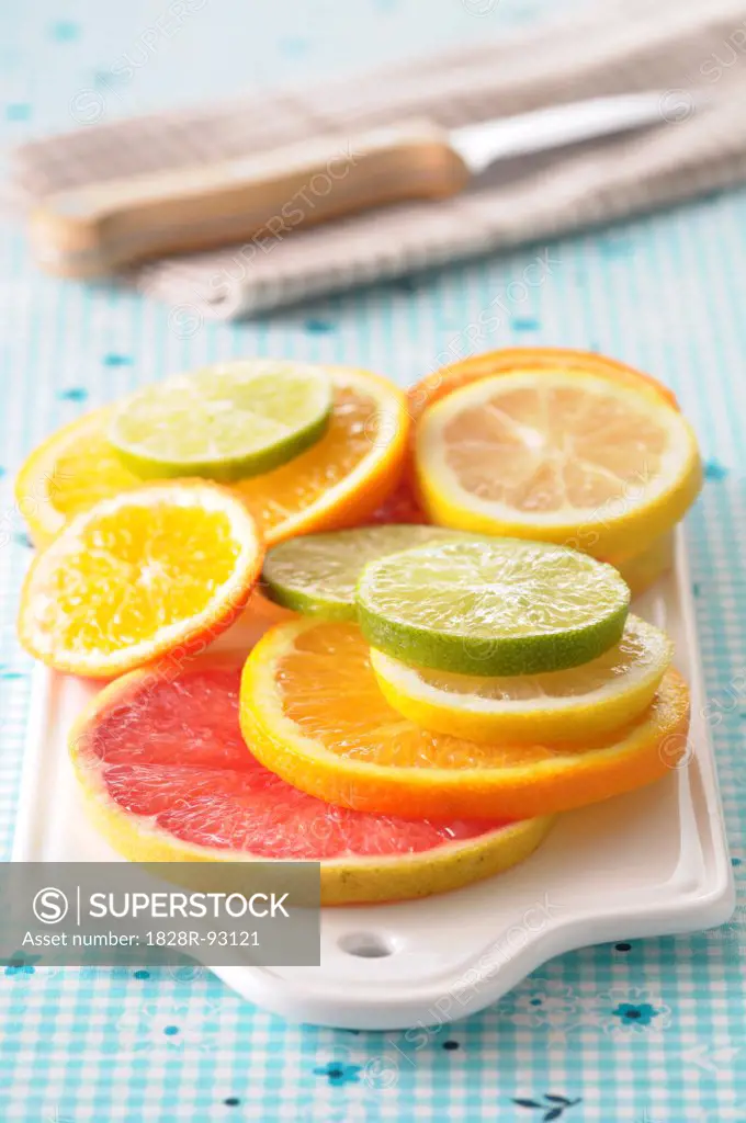 Close-up of Slices of Citrus Fruits on Cutting Board on Blue Backgound