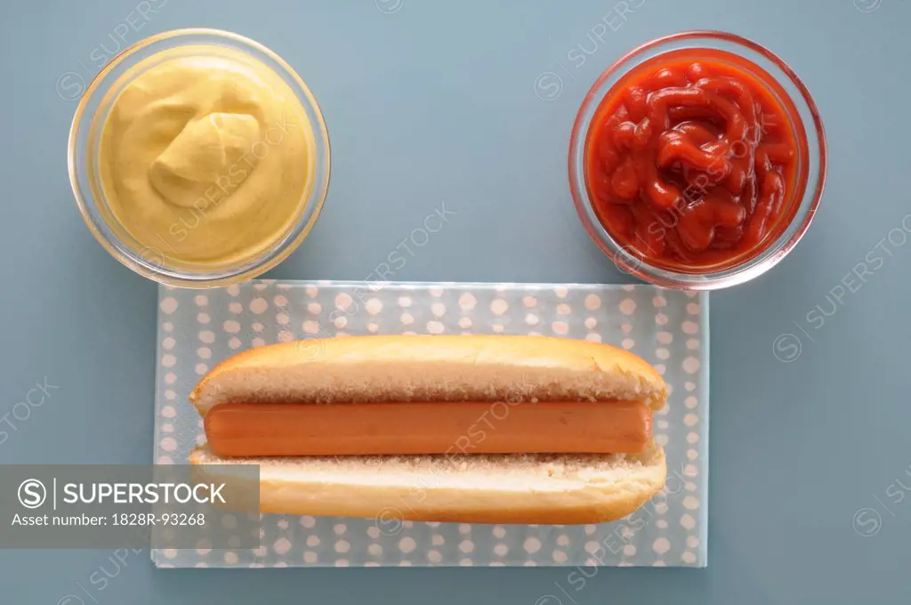 Overhead View of Hot Dog with Bowls of Ketchup and Mayonnaise, Studio Shot
