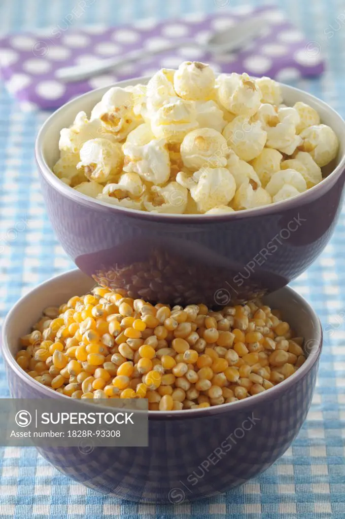 Bowls of Corn Kernels and Popcorn on Blue Gingham Background, Studio Shot