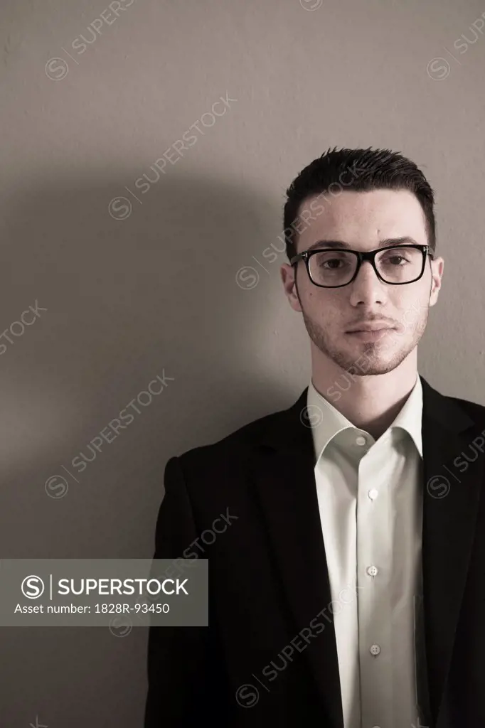 Portrait of Young Man wearing Glasses, Looking at Camera, Studio Shot