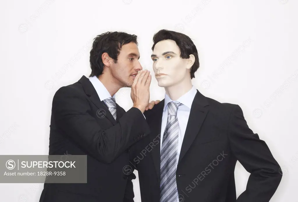 Businessman Whispering To Mannequin