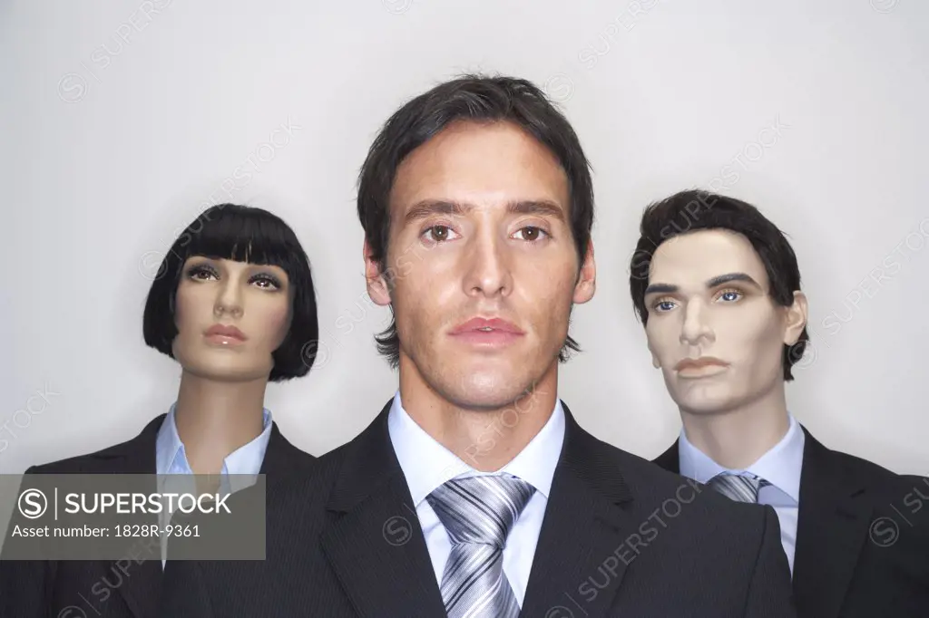 Portrait of Businessman With Mannequins