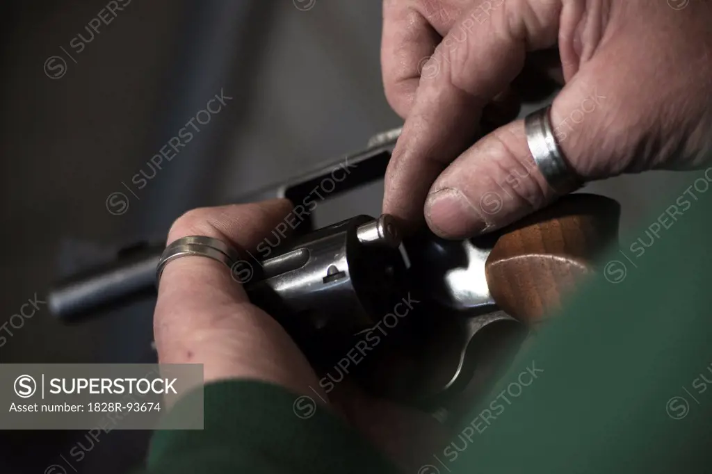 Close-up of Man Loading Bullets into Gun, Mannheim, Baden-Wurttemberg, Germany