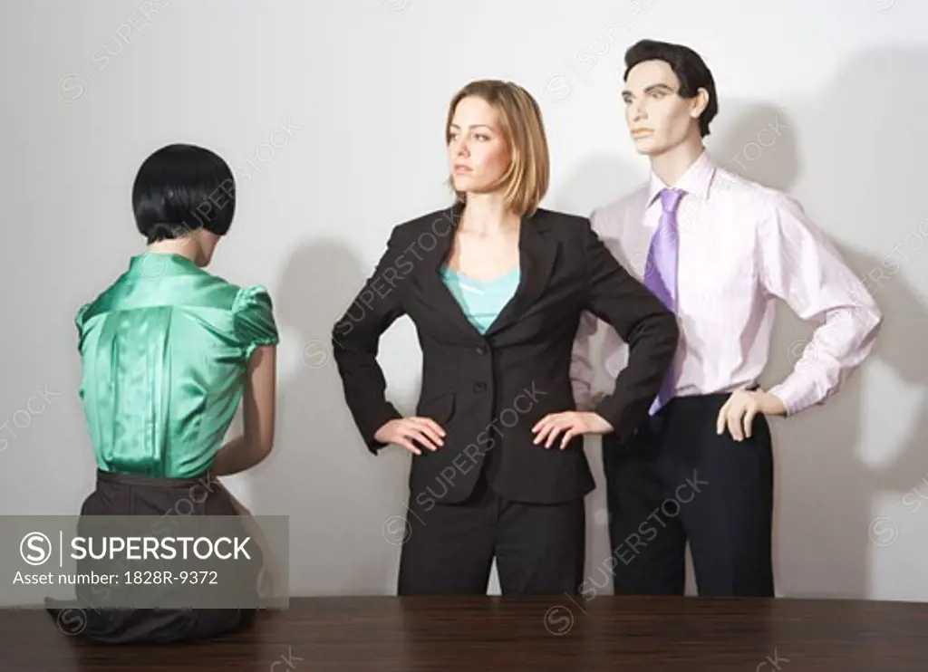 Businesswoman Surrounded By Mannequins