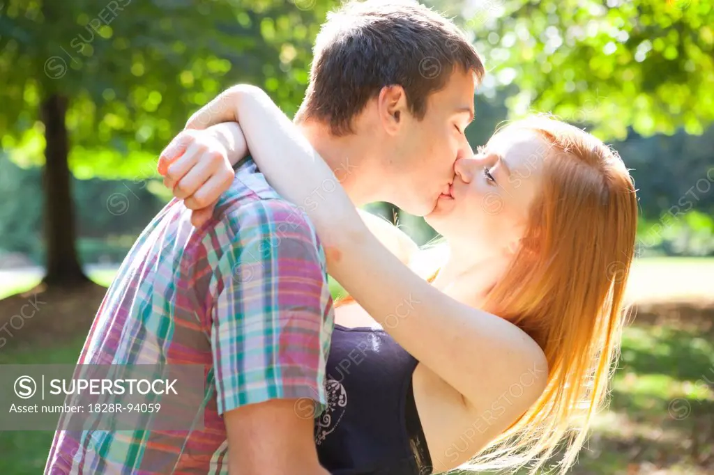 Young Couple Kissing in Park on a Summer Day, Portland, Oregon, USA