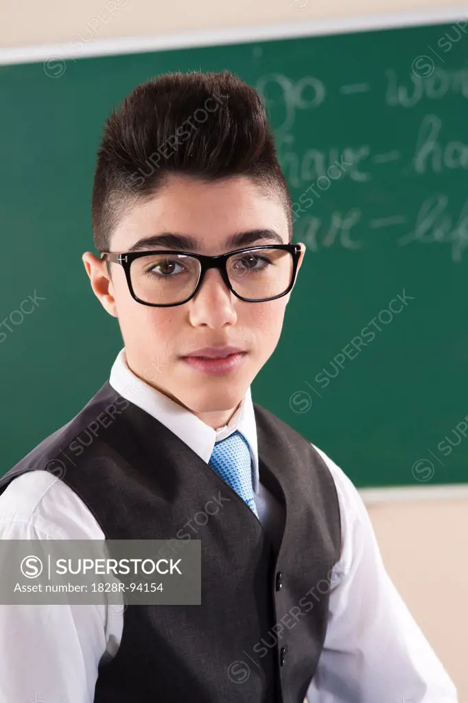 Portrait of Boy in front of Chalkboard in Classroom