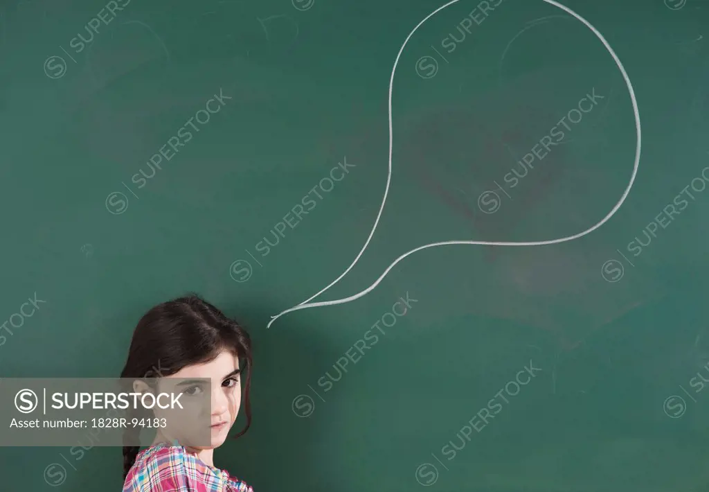 Girl in front of Chalkboard with Speech Bubble in Classroom