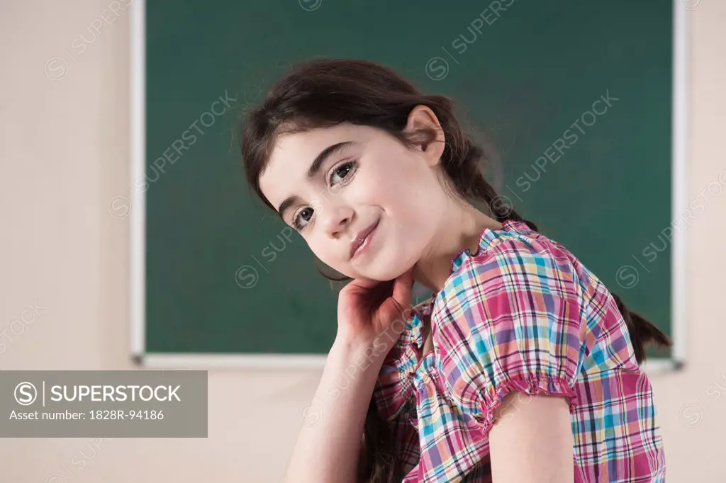 Portrait of Girl in front of Chalkboard in Classroom