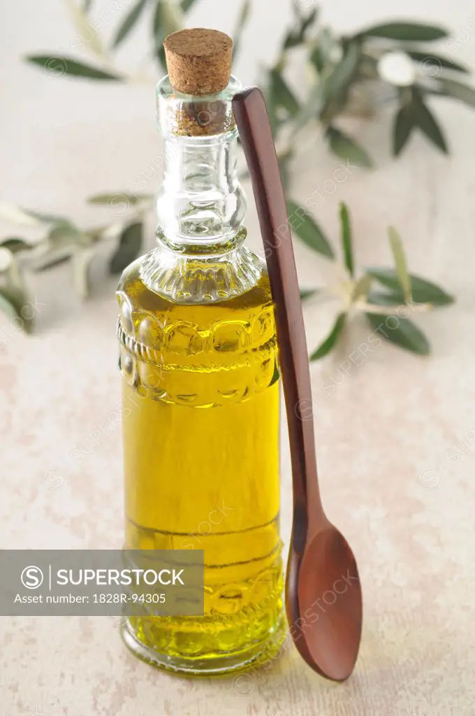 Bottle of Olive Oil with Wooden Spoon