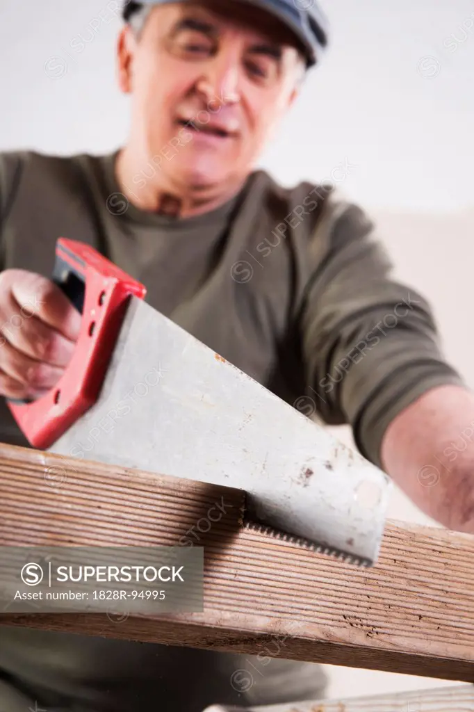 Man Cutting Lumber, Woodworking Project, in Studio