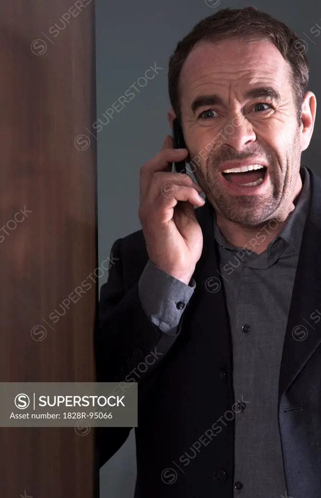 Businessman Using Cellular Telephone, Studio Shot