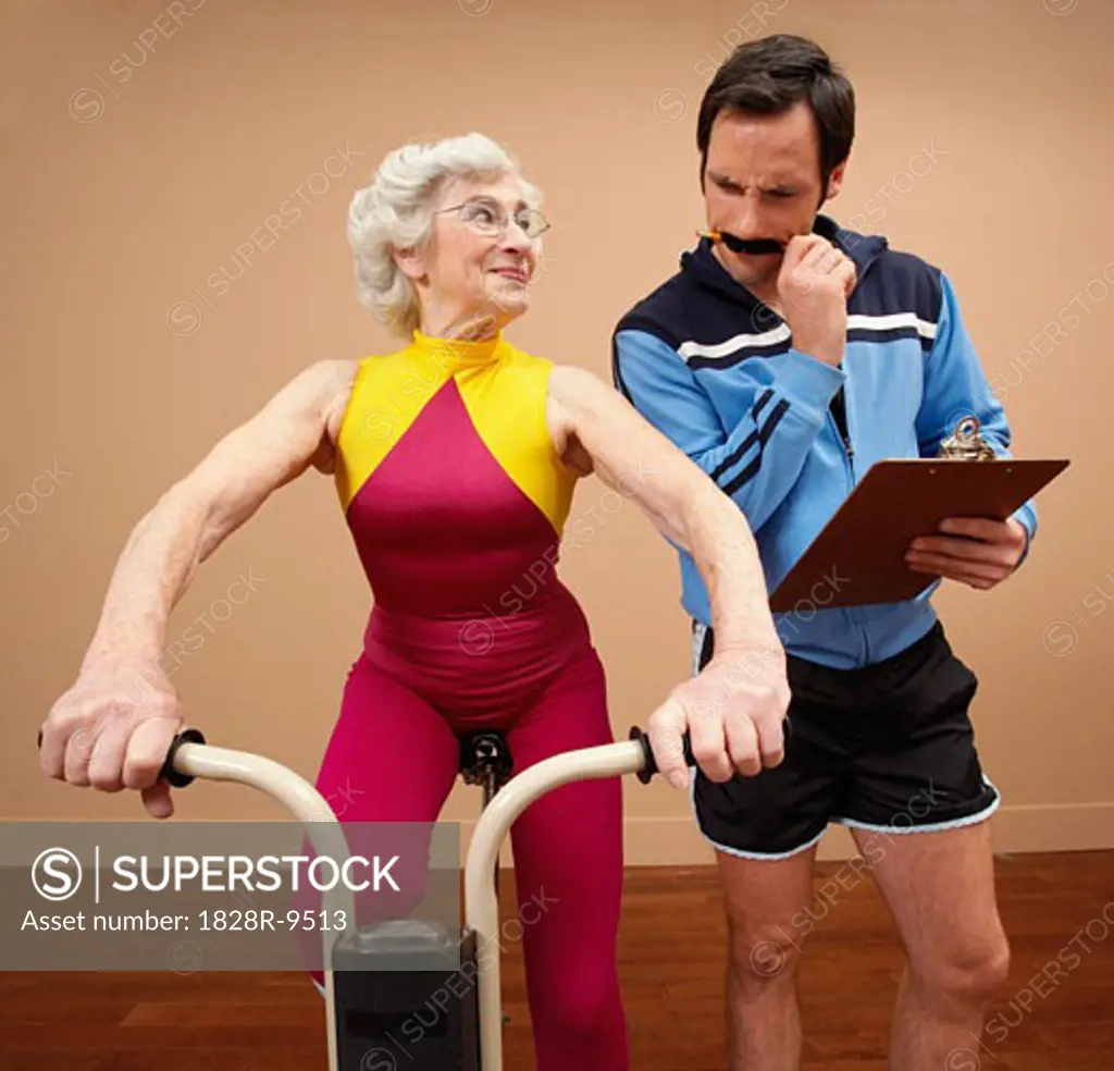 Personal Trainer With Woman on Exercise Bike   
