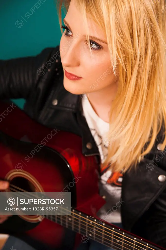 Woman Playing Acoustic Guitar