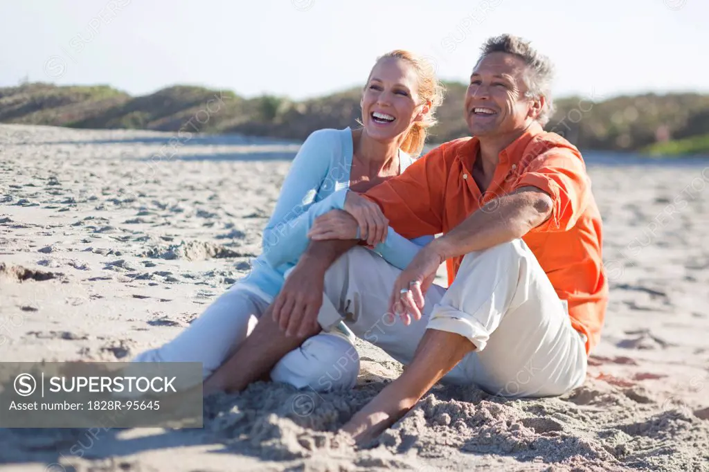 Mature Couple Sitting on Beach, Jupiter, Palm Beach County, Florida, USA,03/13/2013