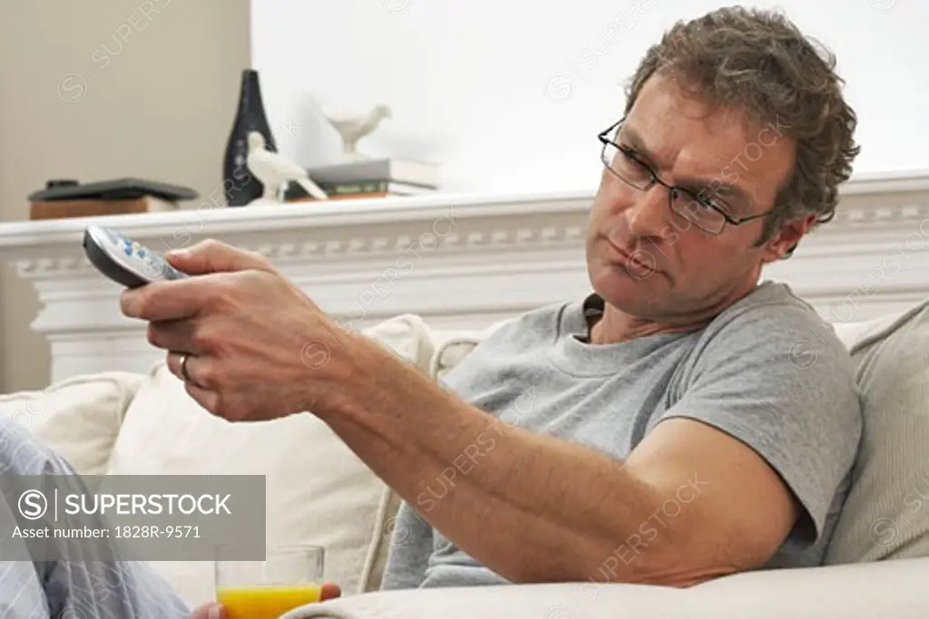 Man with Remote Control and Orange Juice   