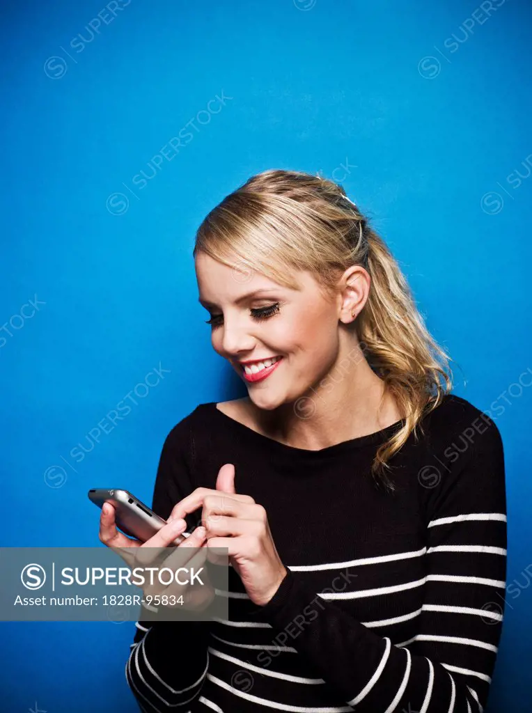 Young Woman using Smart Phone, Studio Shot,02/29/2008