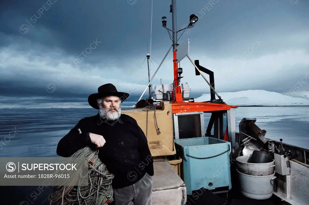 Fisherman with gray beard on his boat on a winter day, Iceland,01/29/2007