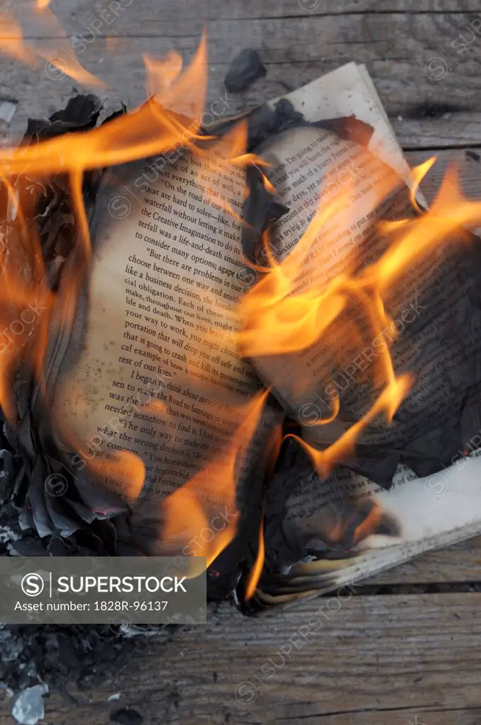 Burning Book on Wooden Background,04/16/2013