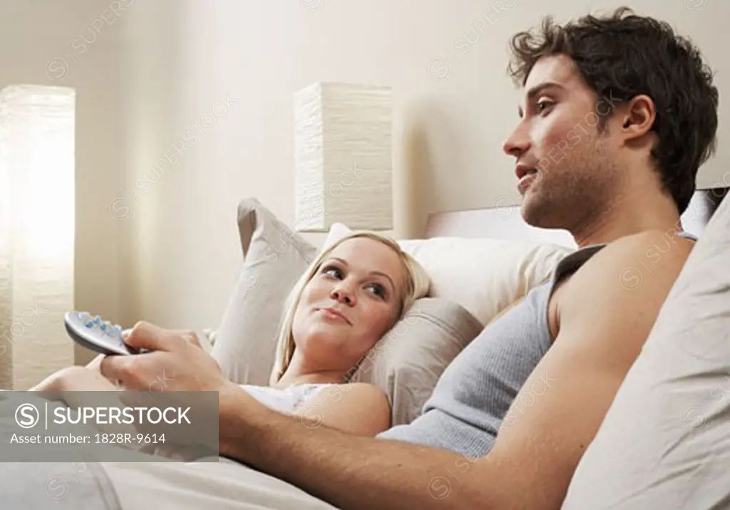 Couple Watching Television in Bed   