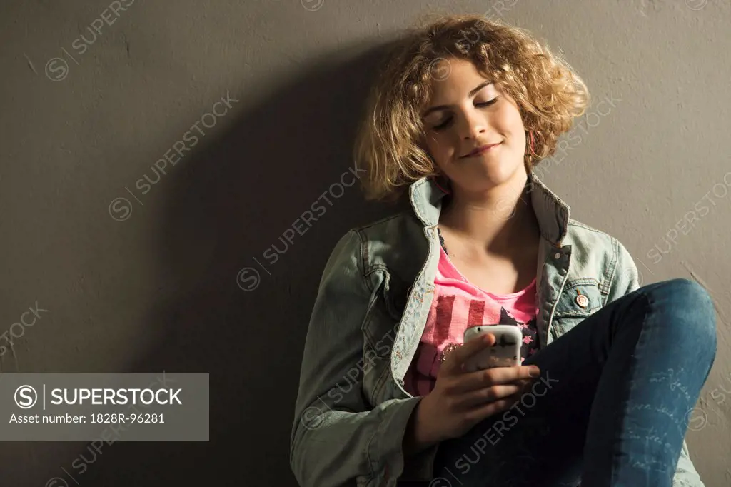 Teenage Girl looking at Cell Phone, Studio Shot,04/28/2013