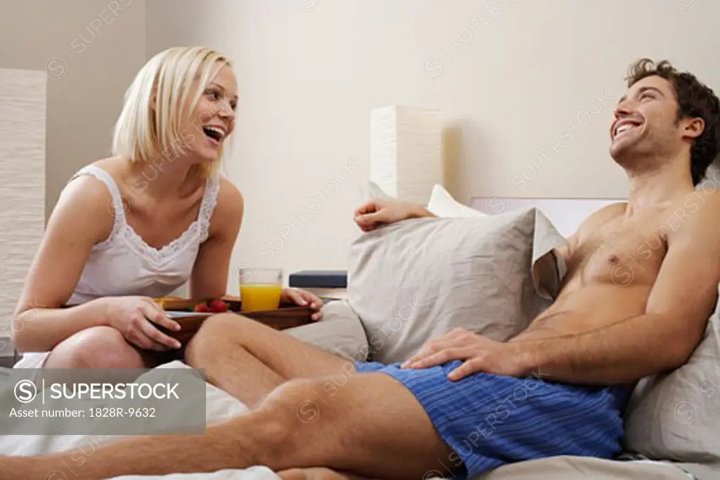 Woman Bringing Man Breakfast in Bed   