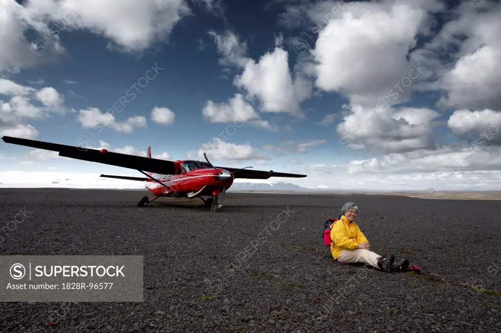 Woman Sitting in front of Crashed Airplane, Nyidalur, Icelandic Highlands, Iceland,08/31/2007