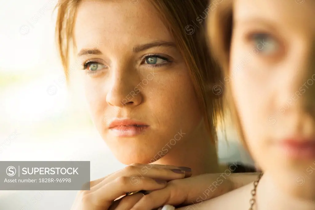Close-up portrait of teenage girl with blurred young woman in foreground,05/05/2013