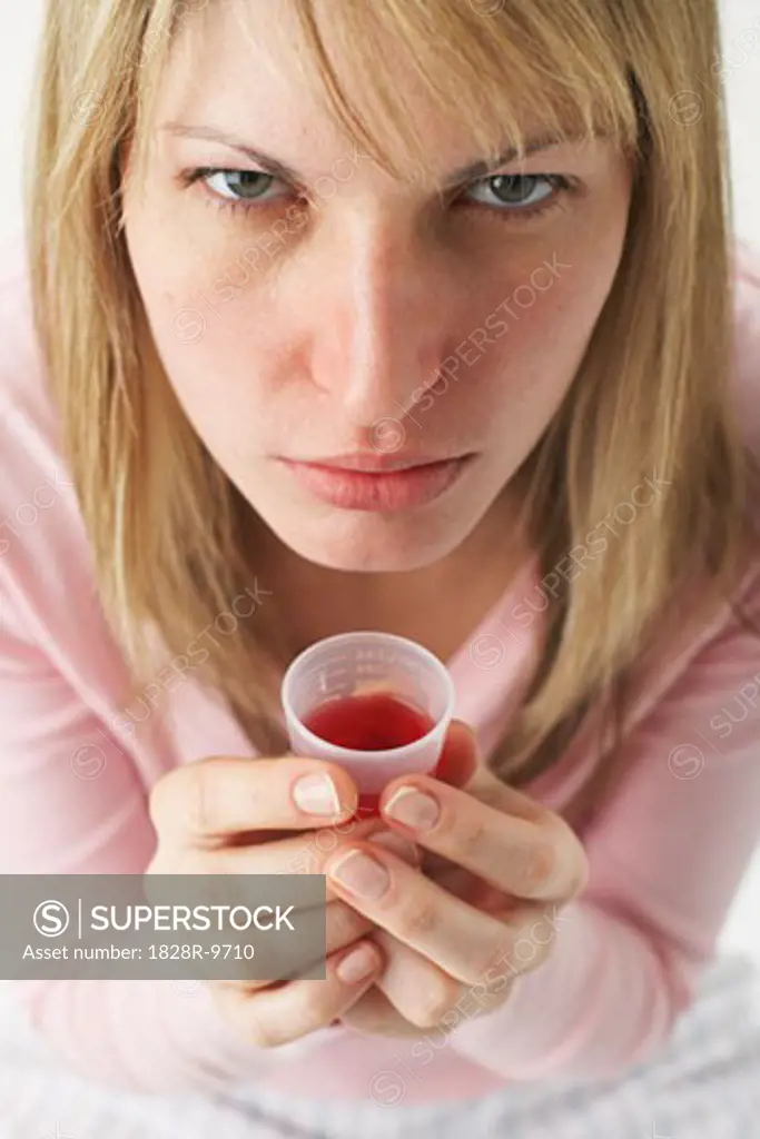 Woman Taking Cough Syrup   
