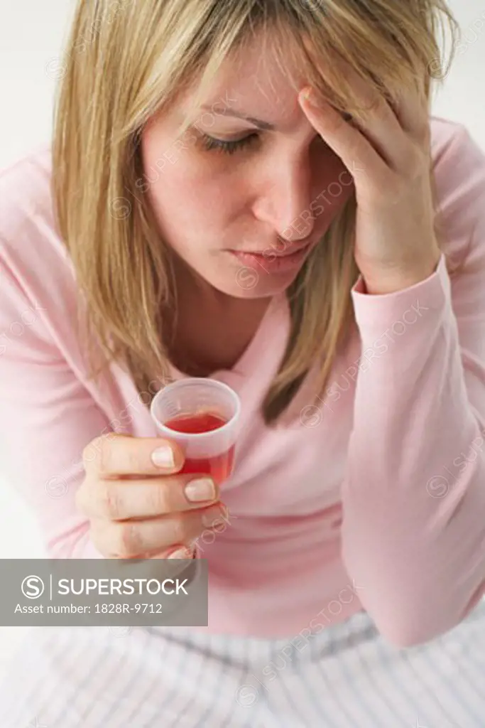Sick Woman Taking Cough Syrup   