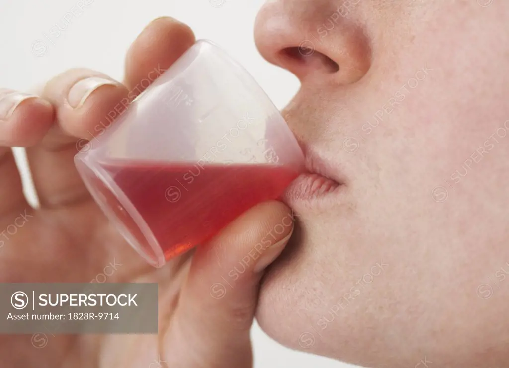 Woman Drinking Cough Syrup   