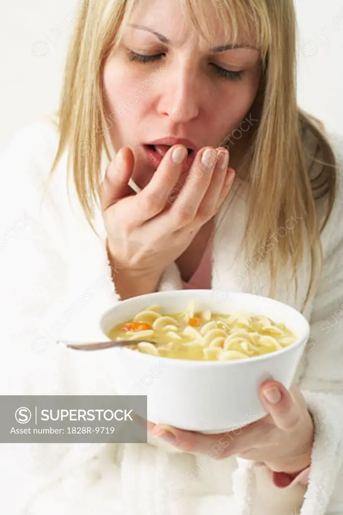 Woman Eating Chicken Noodle Soup   