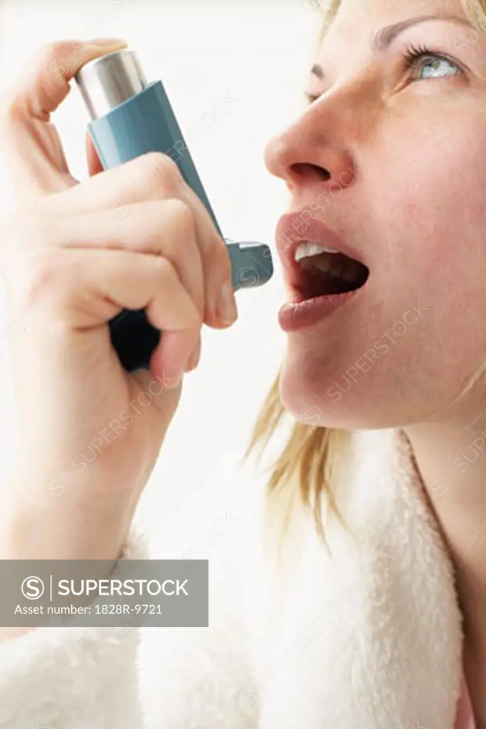 Woman Using Inhaler   