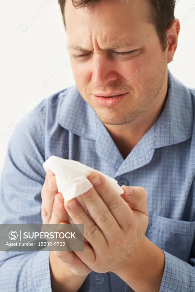 Sick Man Holding Tissue Paper   
