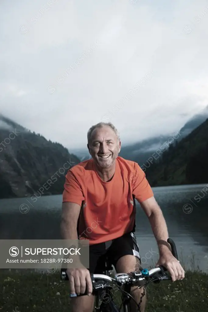 Mature Man Riding Mountain Bike by Vilsalpsee, Tannheim Valley, Tyrol, Austria,06/14/2013