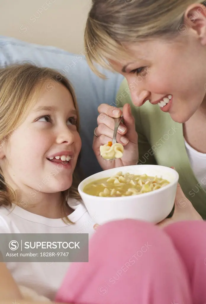 Mother and Daughter Eating Chicken Soup   