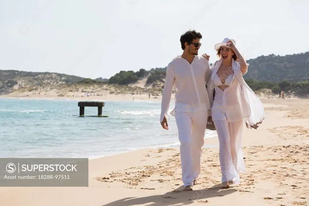 Young couple walking at the beach during summer holidays, Sardinia, Italy,05/20/2013