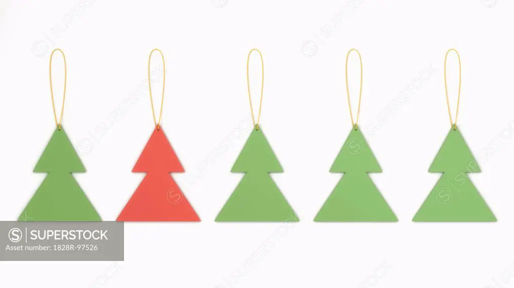 Christmas tree shaped decorations in a row on white background,07/14/2013