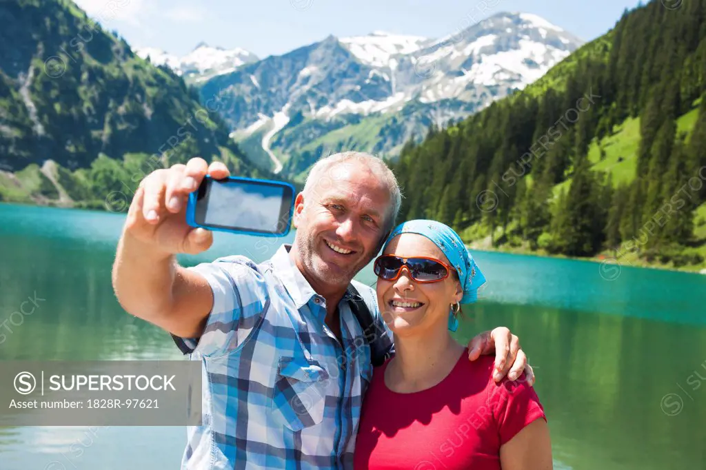 Couple taking Self Portrait by Lake, Vilsalpsee, Tannheim Valley, Tyrol, Austria,06/15/2013
