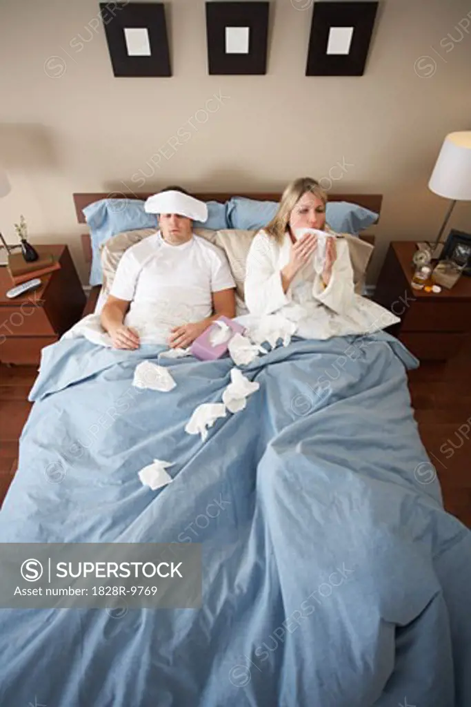 Sick Couple in Bed   