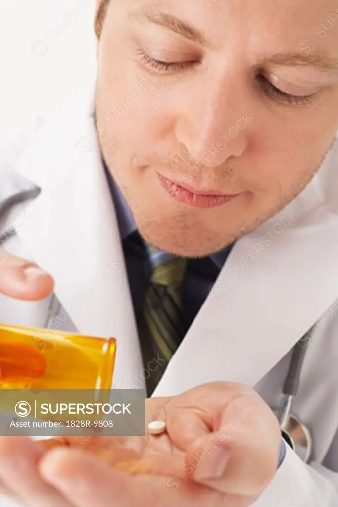 Doctor Holding Bottle of Pills   