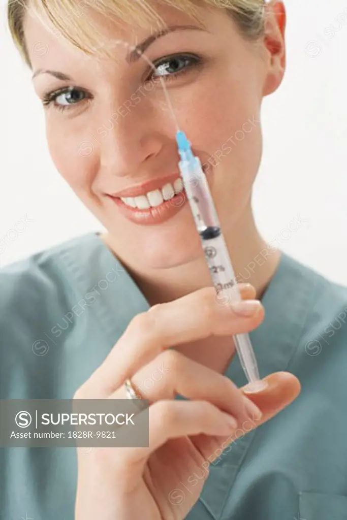 Doctor Holding Syringe   