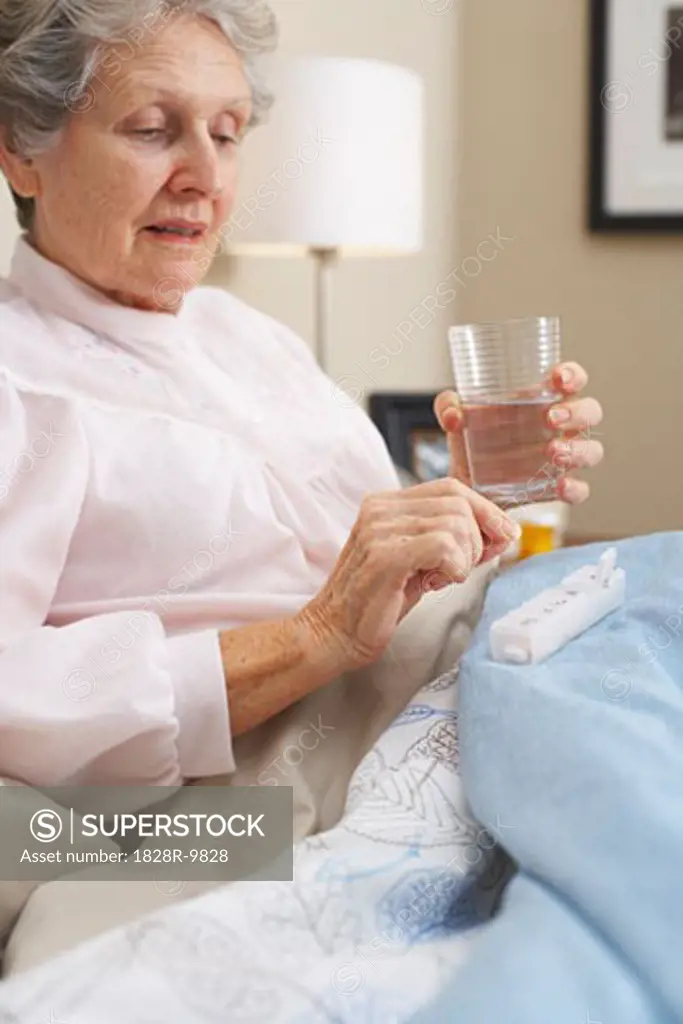 Portrait of Woman Taking Pill   