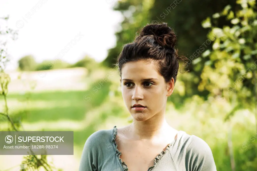 Portrait of teenaged girl outdoors in nature, looking into the distance, Germany,07/12/2013