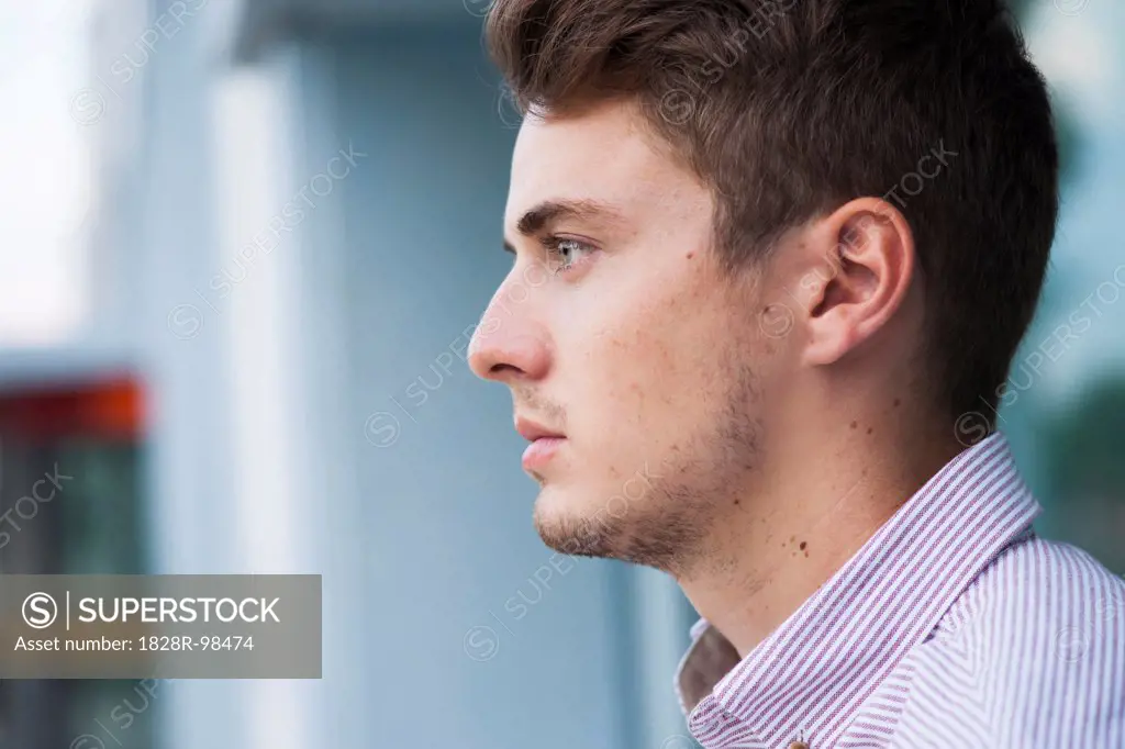 Close-up, side view portrait of young man outdoors, Germany,07/23/2013
