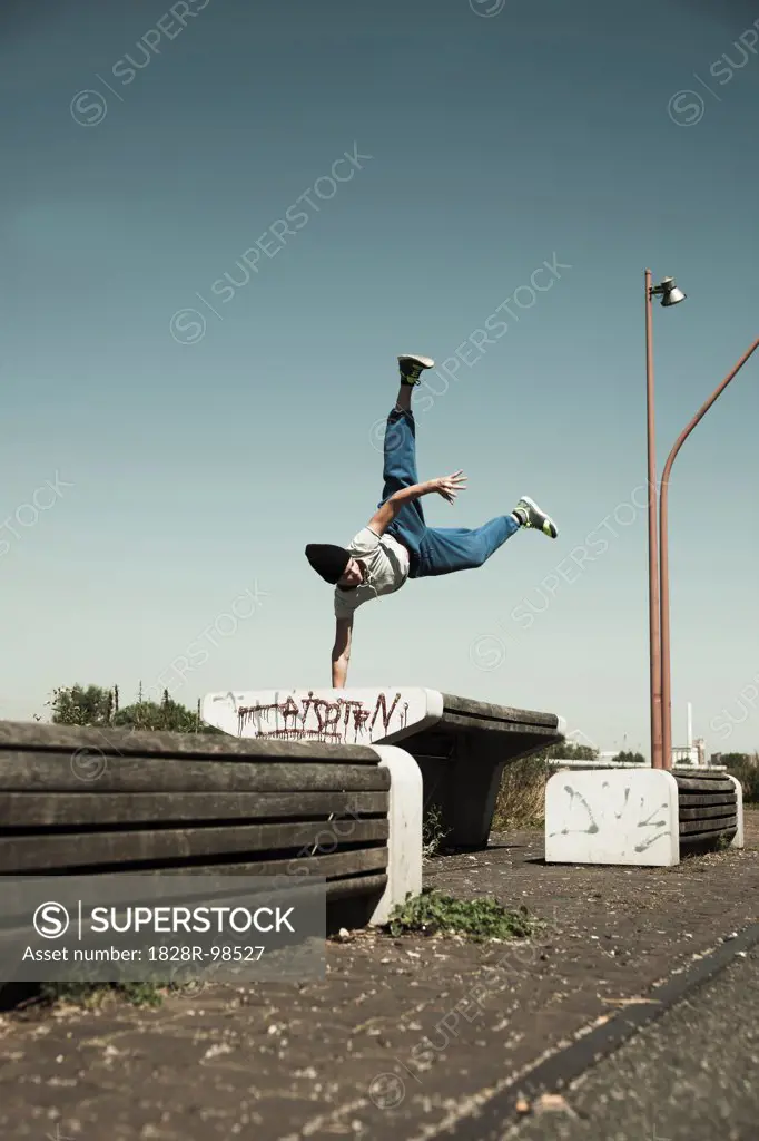 Teenaged boy doing handstand on barrier, freerunning, Germany,08/16/2013
