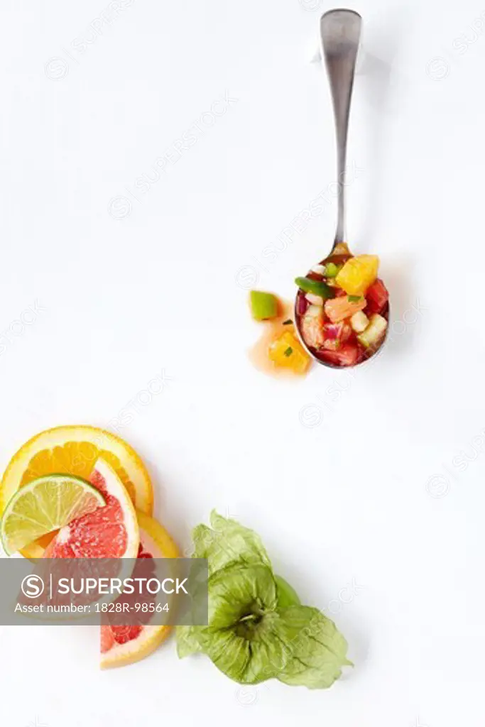 Overhead View of Citrus Gazpacho on Spoon with Citrus Slices and Tomatillo, White Background, Studio Shot,01/06/2011