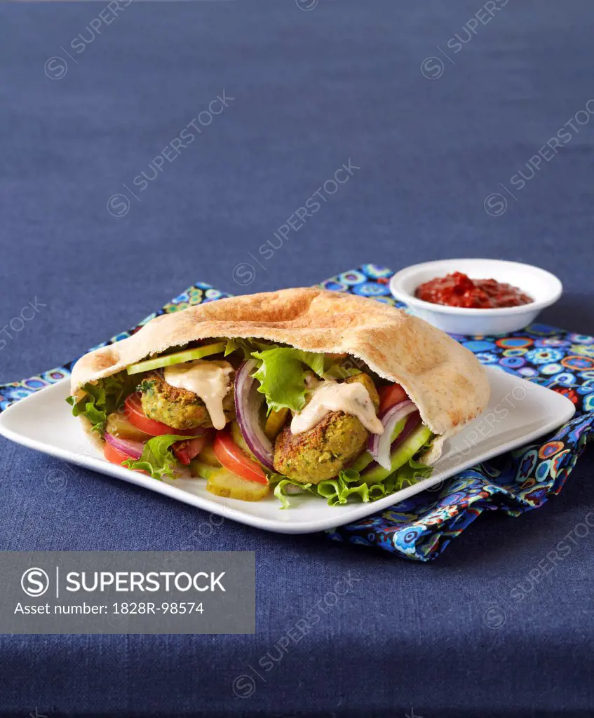 Falafel Sandwich in Pita with Tahini Sauce, Blue Background, Studio Shot,03/04/2011