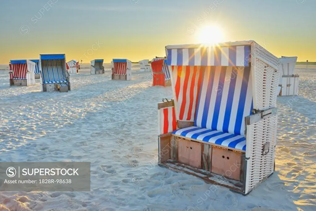 Sun Rising over Beach Chairs at Beach, Norderdeich, Sankt Peter-Ording, North Sea, Schleswig-Holstein, Germany,08/14/2012