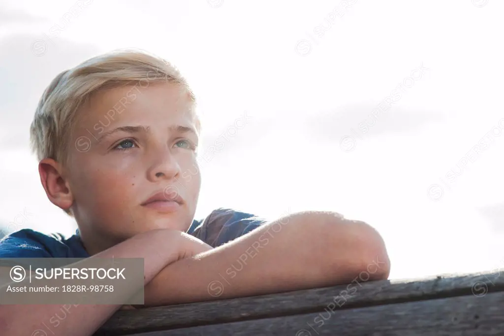 Close-up portrait of boy outdoors, looking into the distance, Germany,08/21/2013